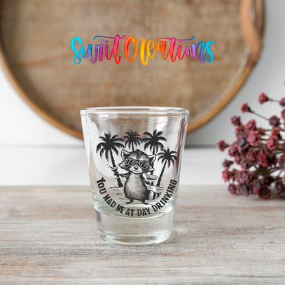 You Had Me at Day Drinking shot glass transfer on a clear glass beside a wooden barrel and dried flowers