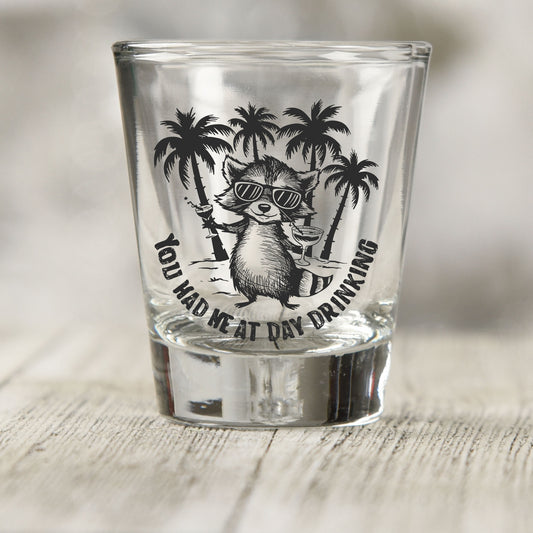You Had Me at Day Drinking shot glass UV DTF transfer with raccoon in sunglasses with palm trees on a clear shot glass