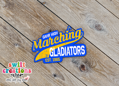 Close-up of the Gahr High Marching Gladiators sticker on rustic wood
